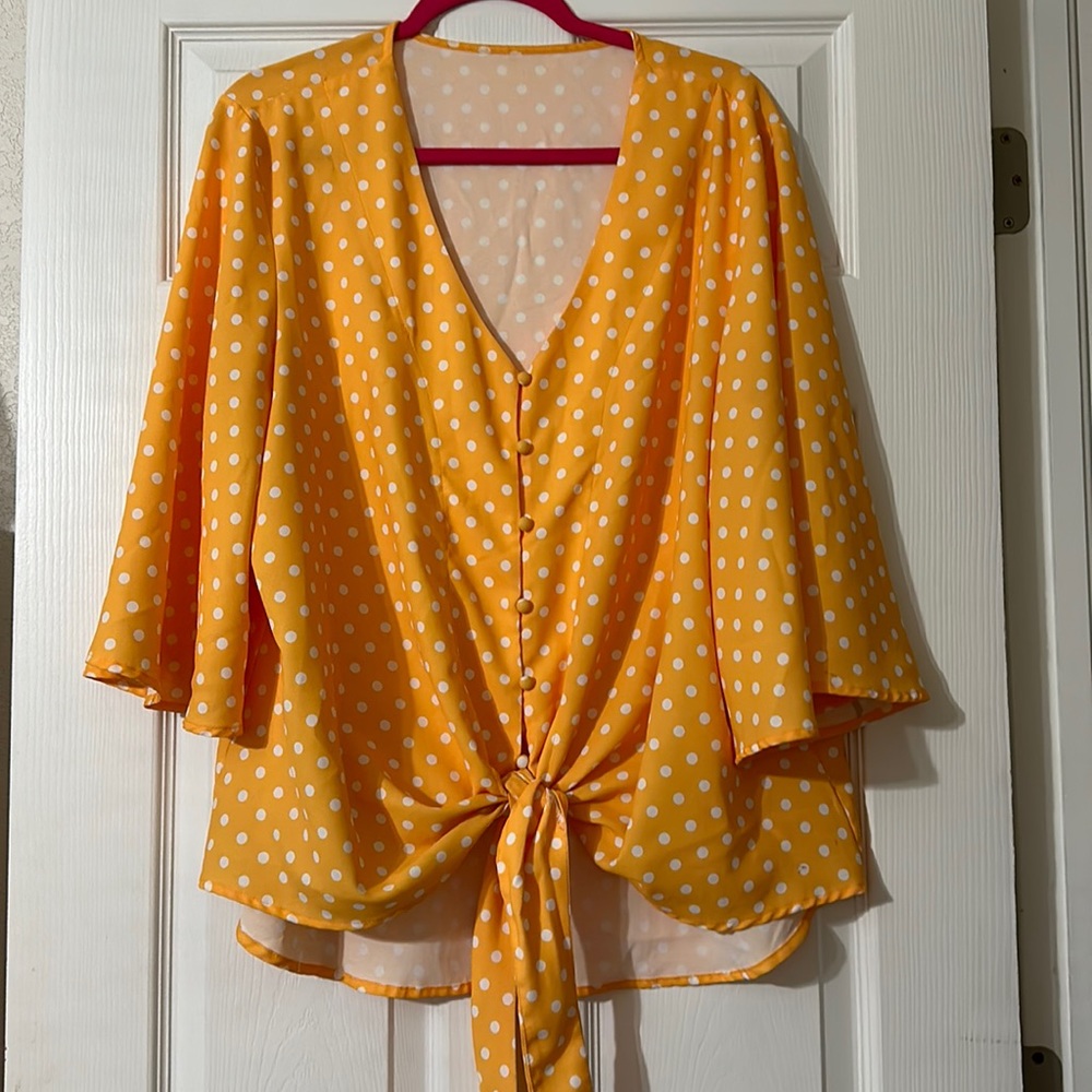 Bright yellow and white polka-dot blouse